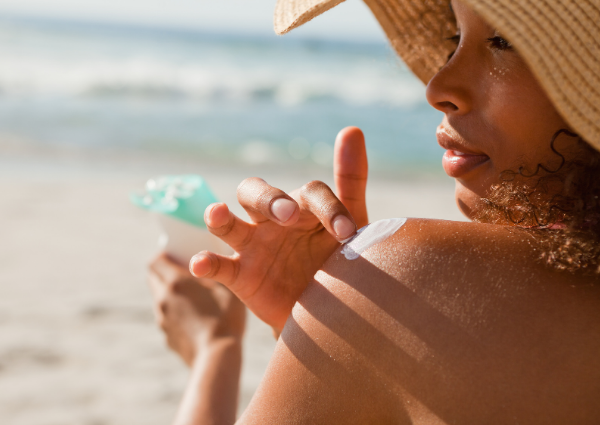  Woman applying sunscreen at the beach