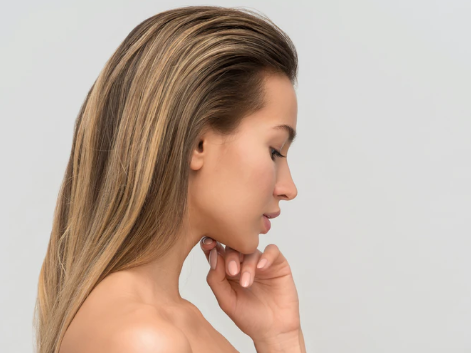 Beauty portrait of a young woman with clear skin looking down