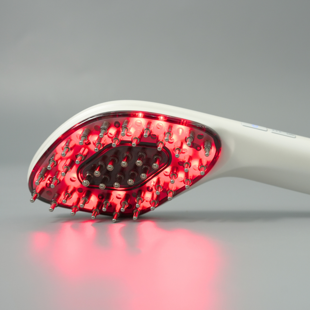 Close up to Reboot Scalp Rejuvenator LED Comb with red LED lights on 