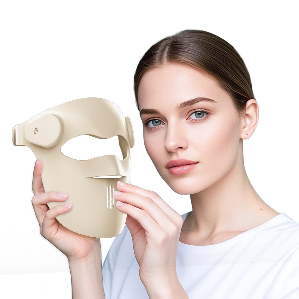 Woman holding the GOOMi 3D Silicone LED Light Therapy Mask beside her face on a white background