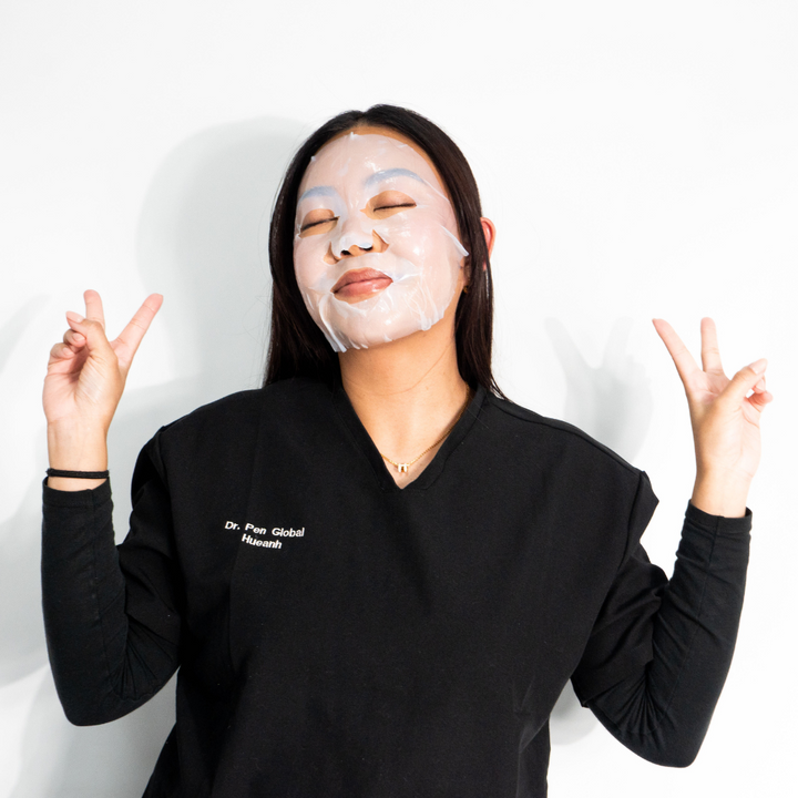 Smiling woman enjoying self-care with Dr. Pen x Peachaboo Hydra Calm Biocellulose Facial Mask, a calming, hydrating mask for radiant, healthy skin.