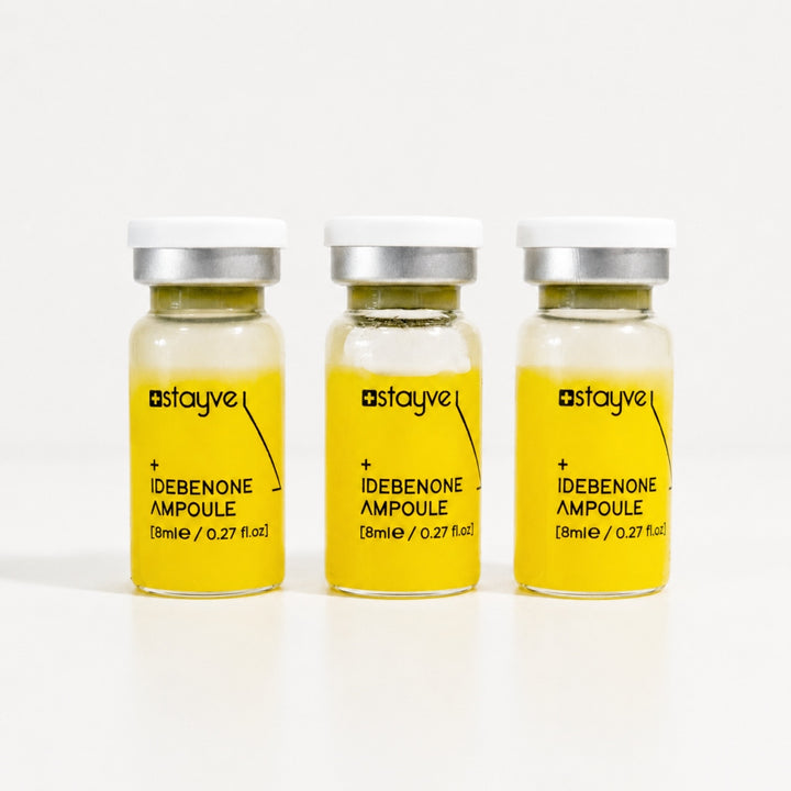 Three Stayve Idebenone Ampoule vials with bright yellow formula for skin booster treatments
