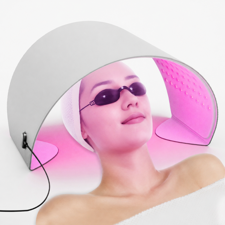Goomi PDT LED Light Therapy Pod in use over the face during an at-home session, with eye protection goggles