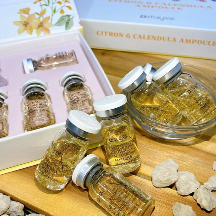 Stayve Citron & Calendula Ampoule Vial bottles with gold-infused serum styled for luxury skincare presentation