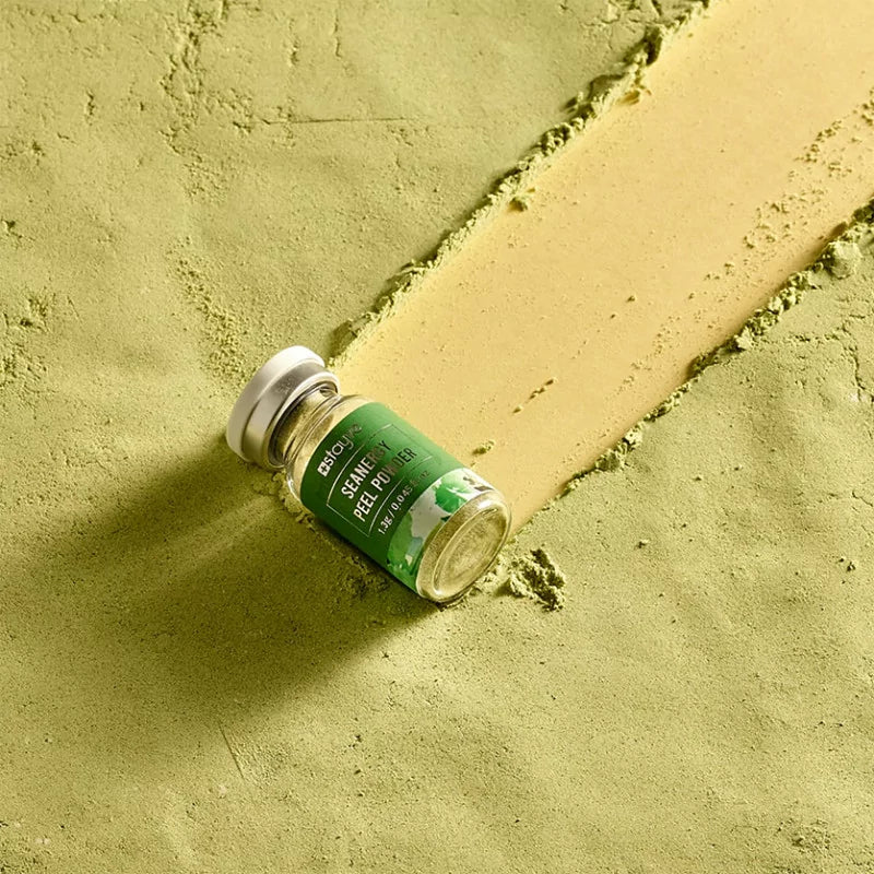 Stayve Seanergy Peel Powder vial placed on green textured surface with exfoliating powder trail