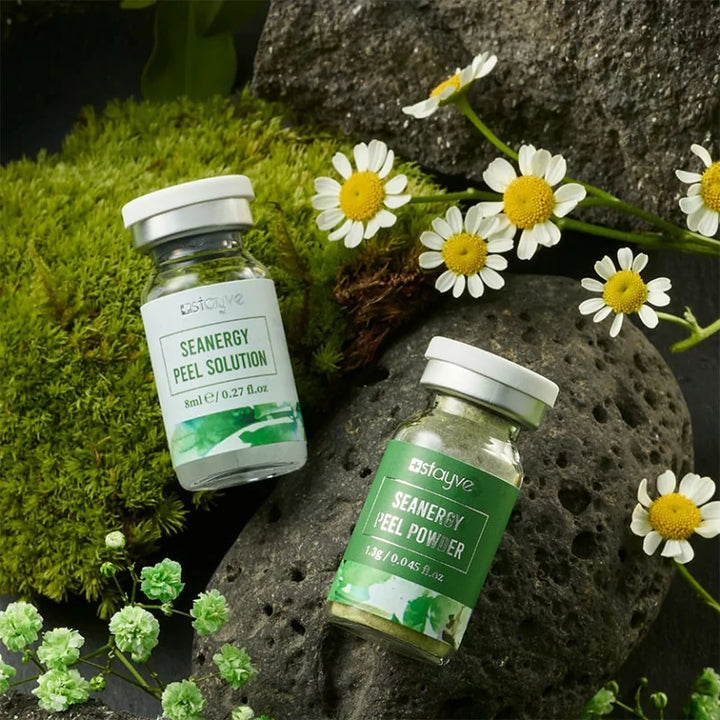 Stayve Seanergy Peel Solution and Powder displayed on moss and stones with white flowers